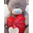 Мишка Тедди держит в лапках сердце
